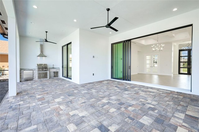 view of patio featuring area for grilling and a ceiling fan