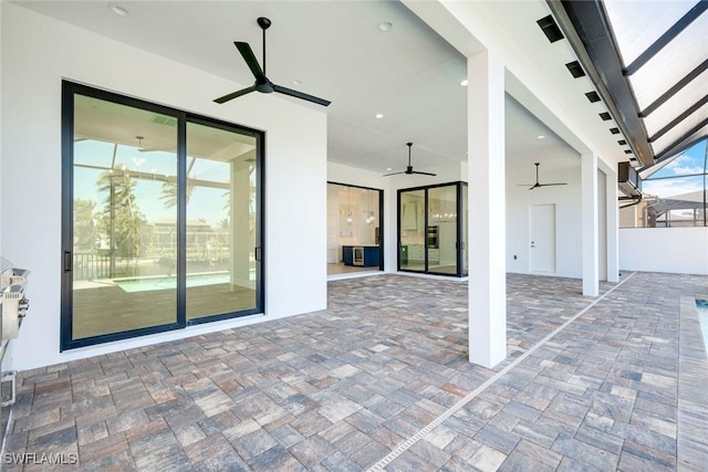 view of patio / terrace with glass enclosure and a ceiling fan