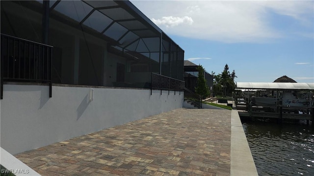 2811 SW 34th Ter, Cape Coral, FL 33914 - view of side of property with a boat dock, glass enclosure, boat lift, and a water view