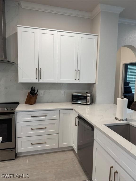 kitchen featuring a toaster, white cabinets, electric stove, dishwasher, and wall chimney exhaust hood