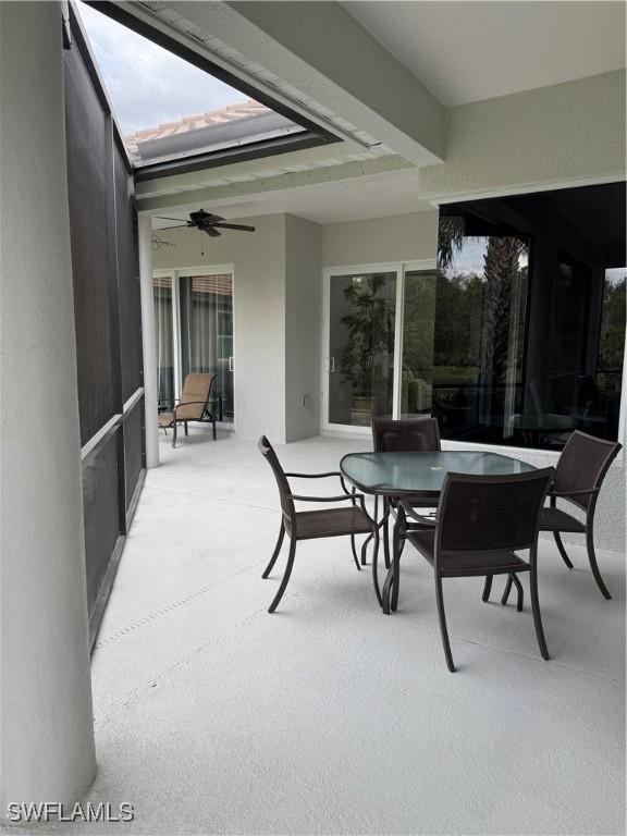 sunroom featuring a ceiling fan