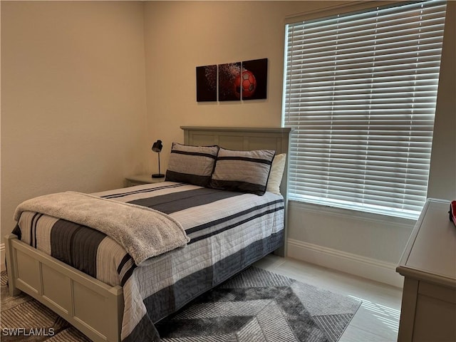 bedroom featuring baseboards