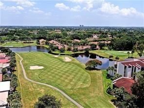 bird's eye view featuring view of golf course and a water view