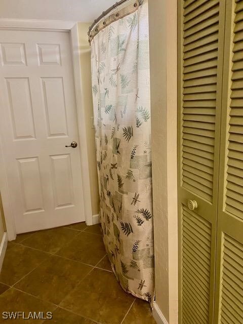 bathroom featuring a shower with curtain and tile patterned floors