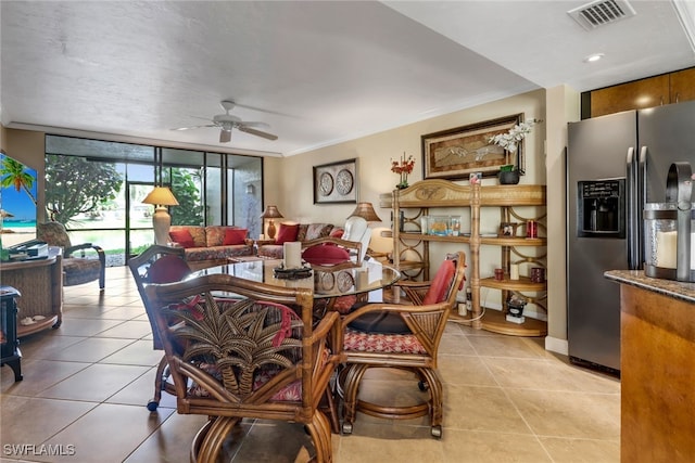 dining room with ornamental molding, floor to ceiling windows, and visible vents