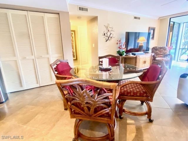 dining area featuring tile patterned floors, visible vents, and crown molding