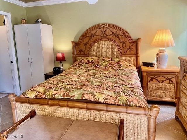 bedroom with tile patterned flooring and crown molding