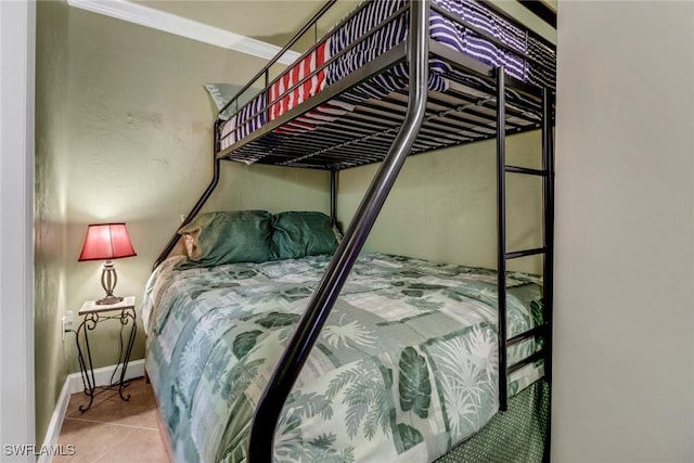 tiled bedroom with crown molding and baseboards