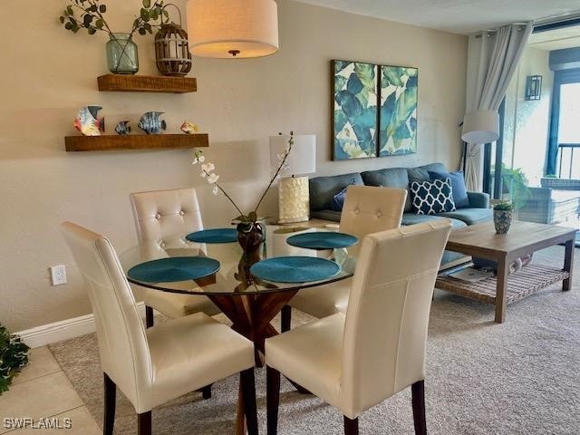 dining room with tile patterned flooring and baseboards