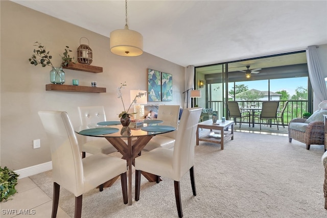 tiled dining space featuring a wall of windows and baseboards