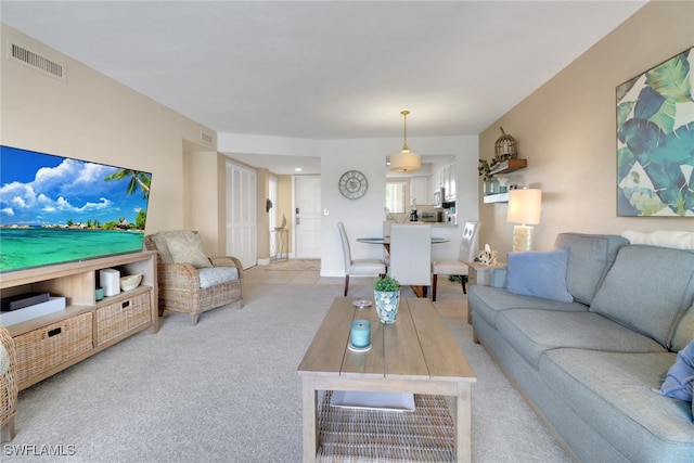 living room with light carpet and visible vents