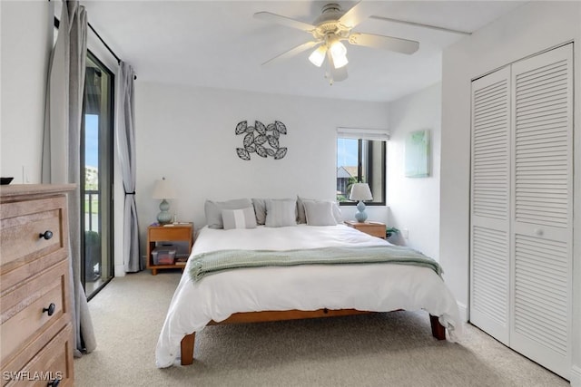 bedroom with light carpet, ceiling fan, and a closet