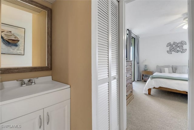 bedroom featuring a sink, a closet, and carpet flooring