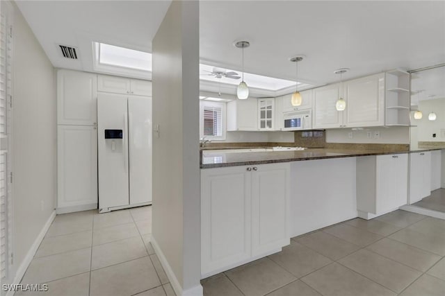 kitchen with white appliances, light tile patterned floors, visible vents, white cabinetry, and open shelves