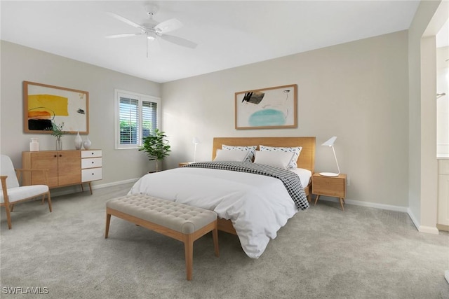 bedroom with baseboards, ceiling fan, and light colored carpet