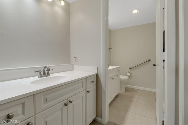 bathroom featuring toilet, tile patterned flooring, vanity, and baseboards