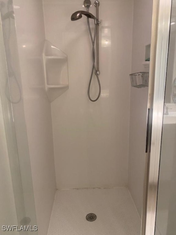 bathroom featuring a shower stall and tile patterned floors