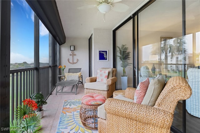 sunroom / solarium featuring a ceiling fan