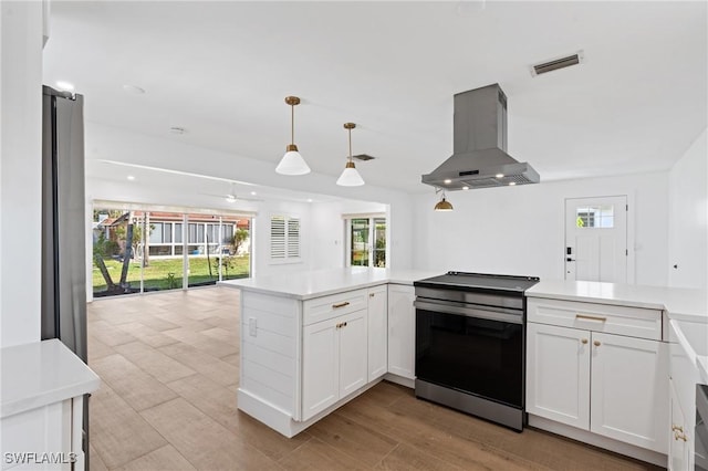 kitchen with visible vents, white cabinets, open floor plan, island exhaust hood, and stainless steel electric stove