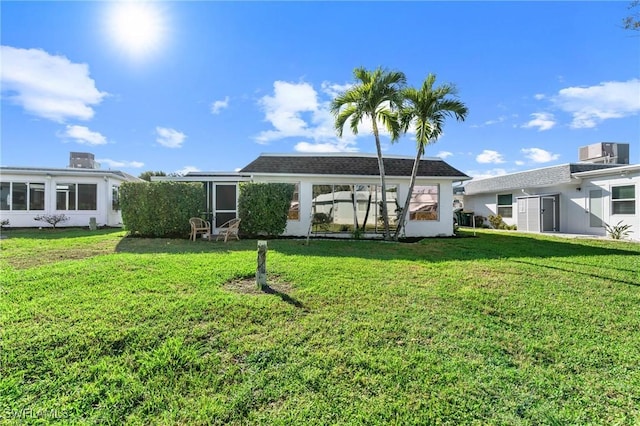 rear view of property with a yard