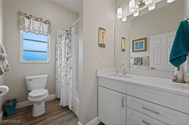 bathroom with toilet, shower / tub combo, vanity, wood finished floors, and baseboards