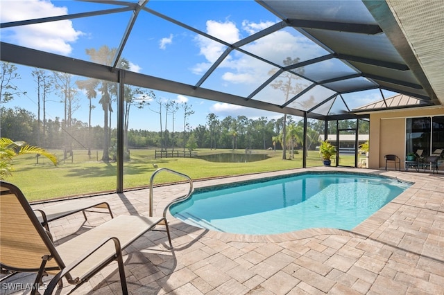 outdoor pool featuring a lawn, a patio area, and a lanai