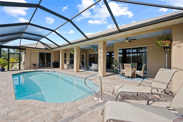 outdoor pool with a lanai, a patio area, ceiling fan, and outdoor dining space