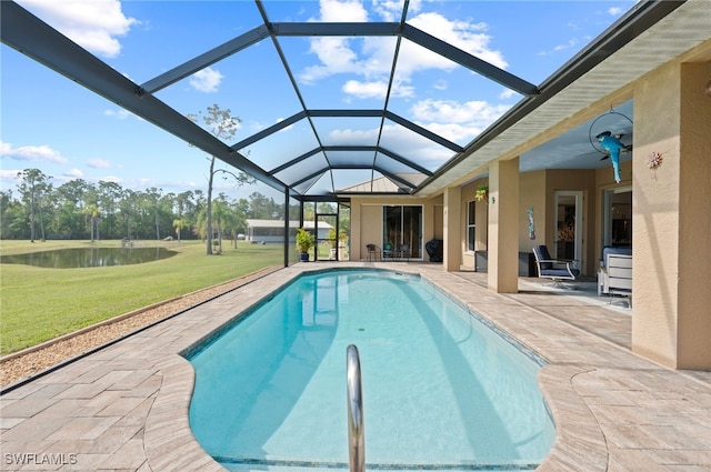 outdoor pool featuring a yard, a patio area, a lanai, and a water view