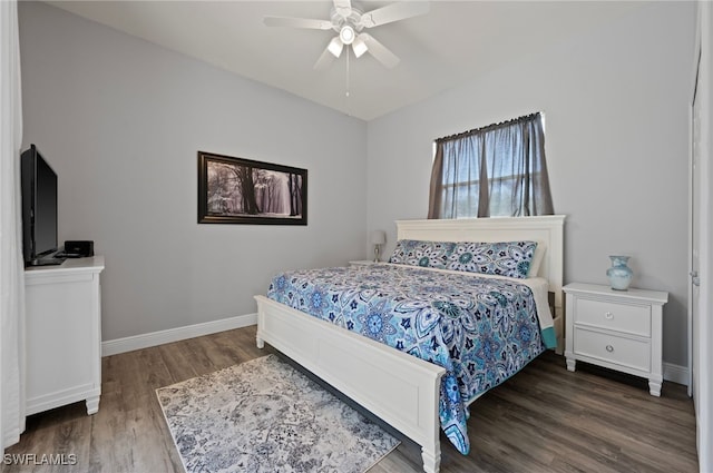 bedroom with ceiling fan, wood finished floors, and baseboards