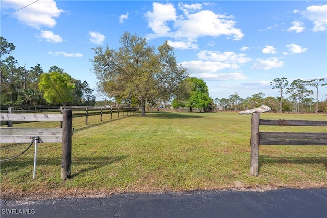 view of yard featuring a rural view and fence