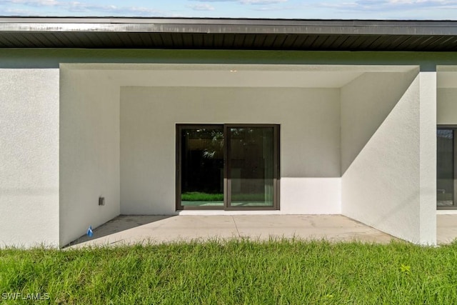 back of house with stucco siding