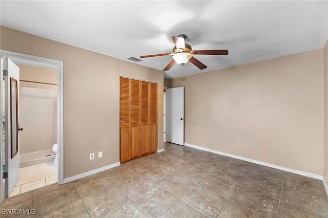 unfurnished bedroom featuring a closet, visible vents, ceiling fan, ensuite bath, and baseboards