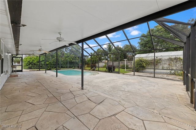 view of swimming pool with a fenced in pool, a lanai, ceiling fan, and a patio