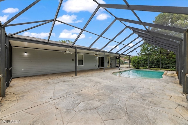 pool with ceiling fan, a patio, and glass enclosure