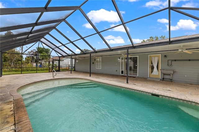 pool featuring a patio area, glass enclosure, and a ceiling fan