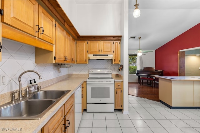 kitchen featuring lofted ceiling, under cabinet range hood, white appliances, a sink, and visible vents