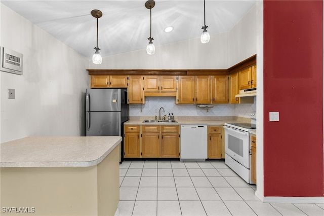 kitchen featuring under cabinet range hood, white appliances, a sink, light countertops, and backsplash