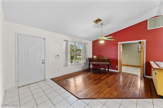 entryway with visible vents, vaulted ceiling, light wood finished floors, and ceiling fan