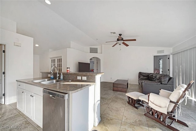 kitchen featuring arched walkways, a sink, open floor plan, stainless steel dishwasher, and a center island with sink