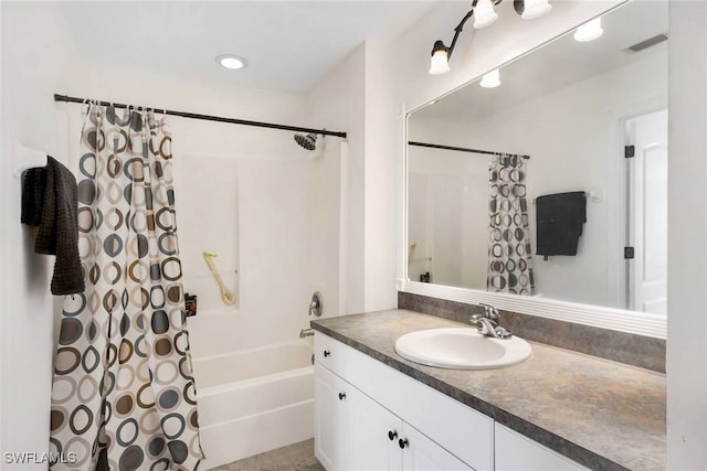 bathroom with visible vents, vanity, and shower / bath combo with shower curtain