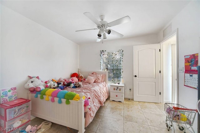 bedroom with a ceiling fan and tile patterned floors