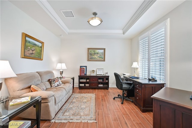 office featuring baseboards, visible vents, wood tiled floor, a tray ceiling, and crown molding