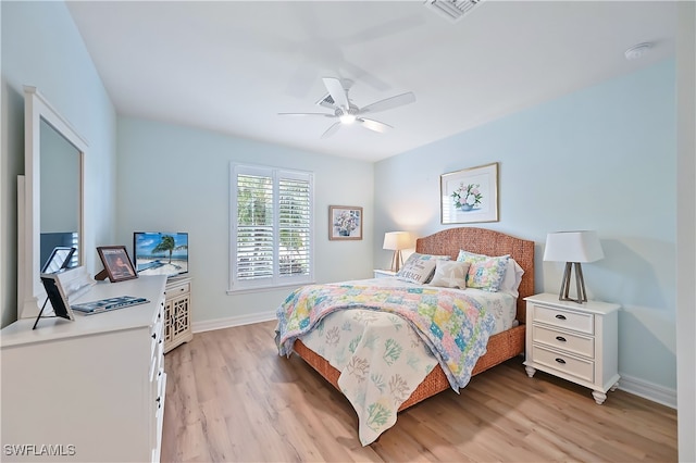 bedroom with light wood-style flooring, visible vents, ceiling fan, and baseboards