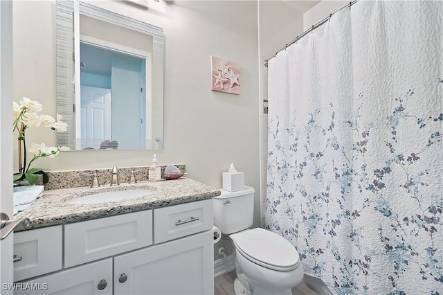 full bathroom with toilet, curtained shower, and vanity