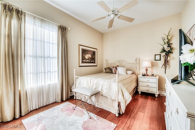 10731 Wintercress Dr, Estero, FL 34135 - bedroom with dark wood-style flooring, multiple windows, and a ceiling fan