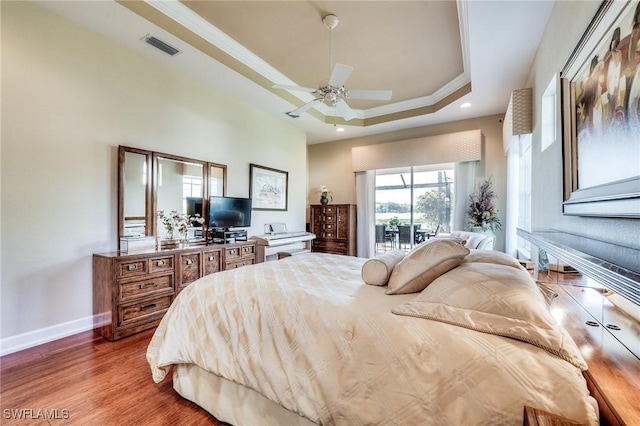 10731 Wintercress Dr, Estero, FL 34135 - bedroom with crown molding, baseboards, a raised ceiling, visible vents, and wood finished floors