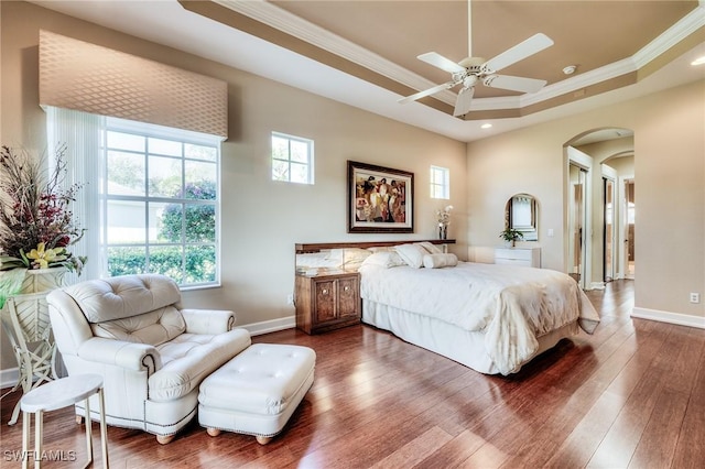10731 Wintercress Dr, Estero, FL 34135 - bedroom featuring a raised ceiling, wood-type flooring, baseboards, arched walkways, and ornamental molding