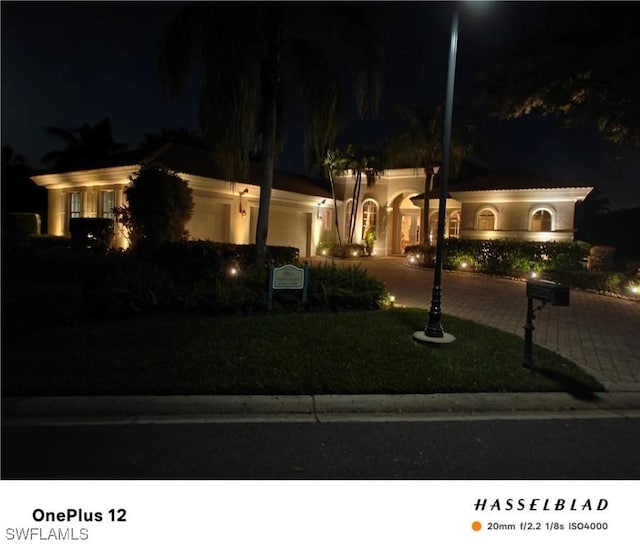 10731 Wintercress Dr, Estero, FL 34135 - mediterranean / spanish house with curved driveway and a lawn