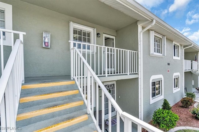 view of exterior entry featuring stucco siding