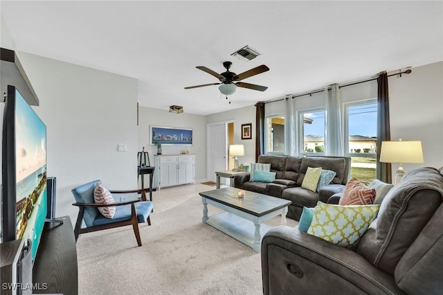 living room with light carpet, ceiling fan, and visible vents